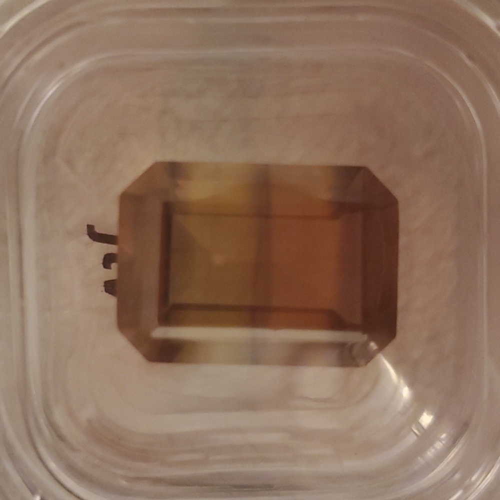 Loose stone called banded flourite. Mostly browns. Emerald cut